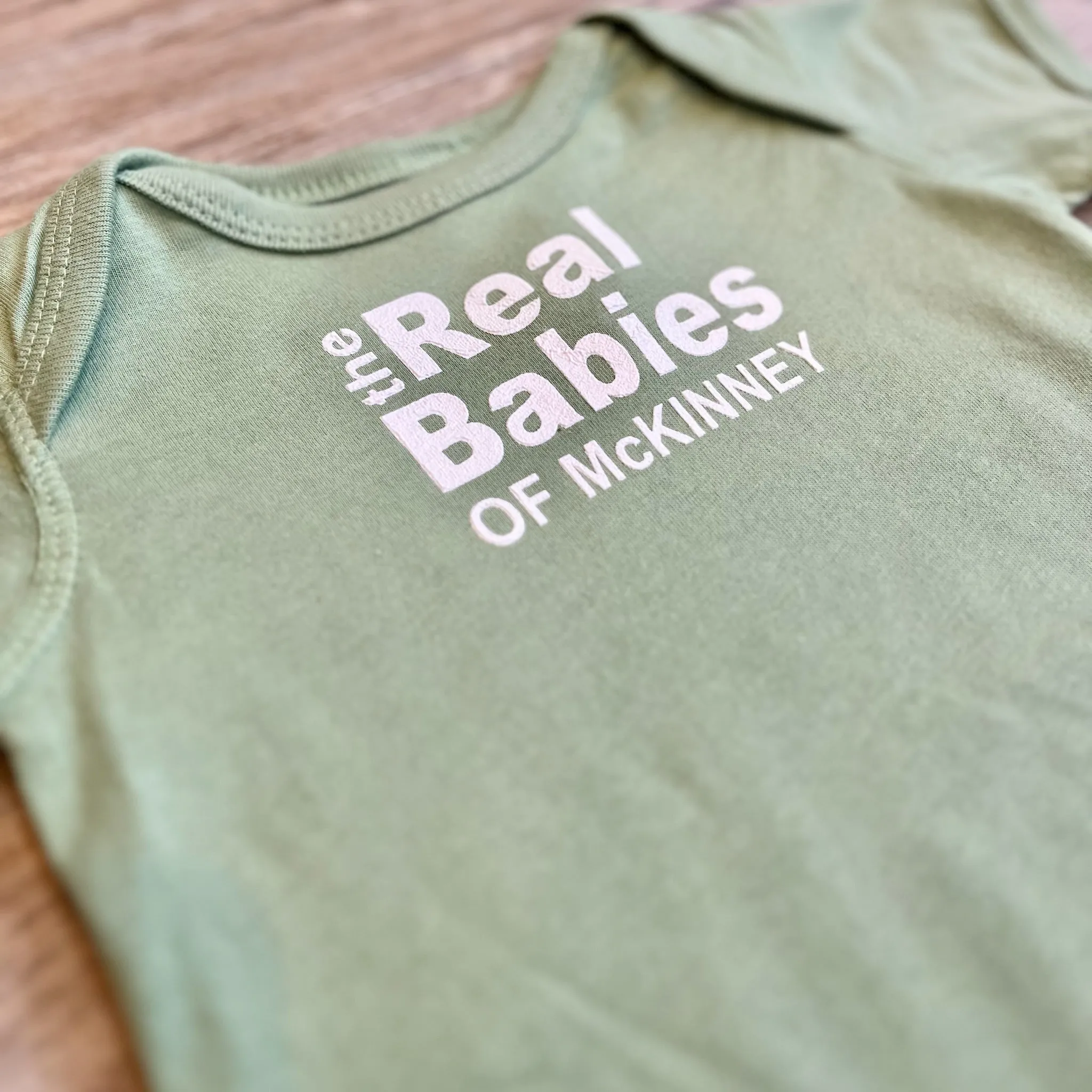Real Babies of McKinney Baby Onesie